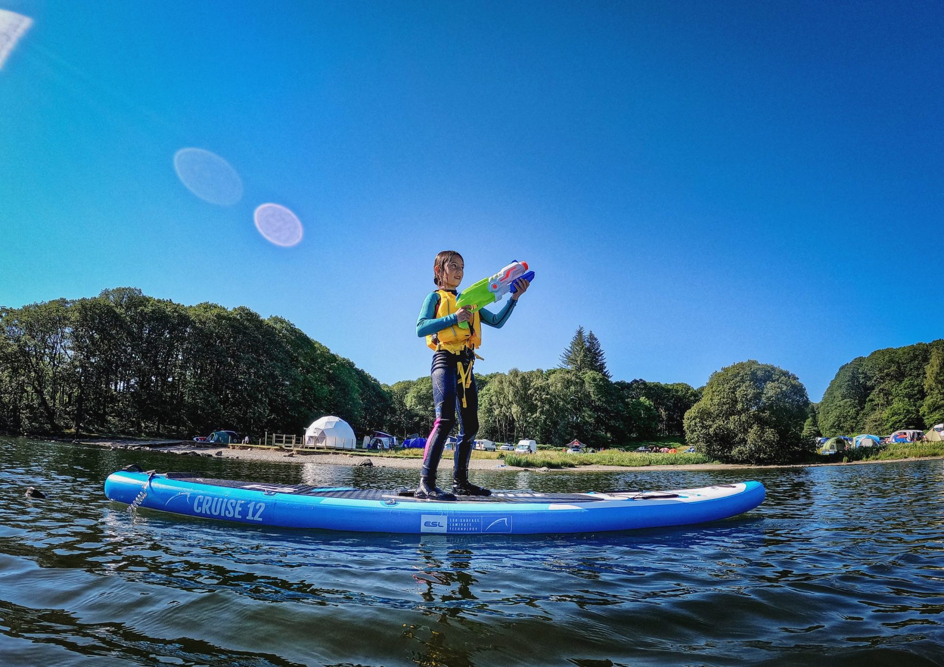 young girl on a stand up paddle board